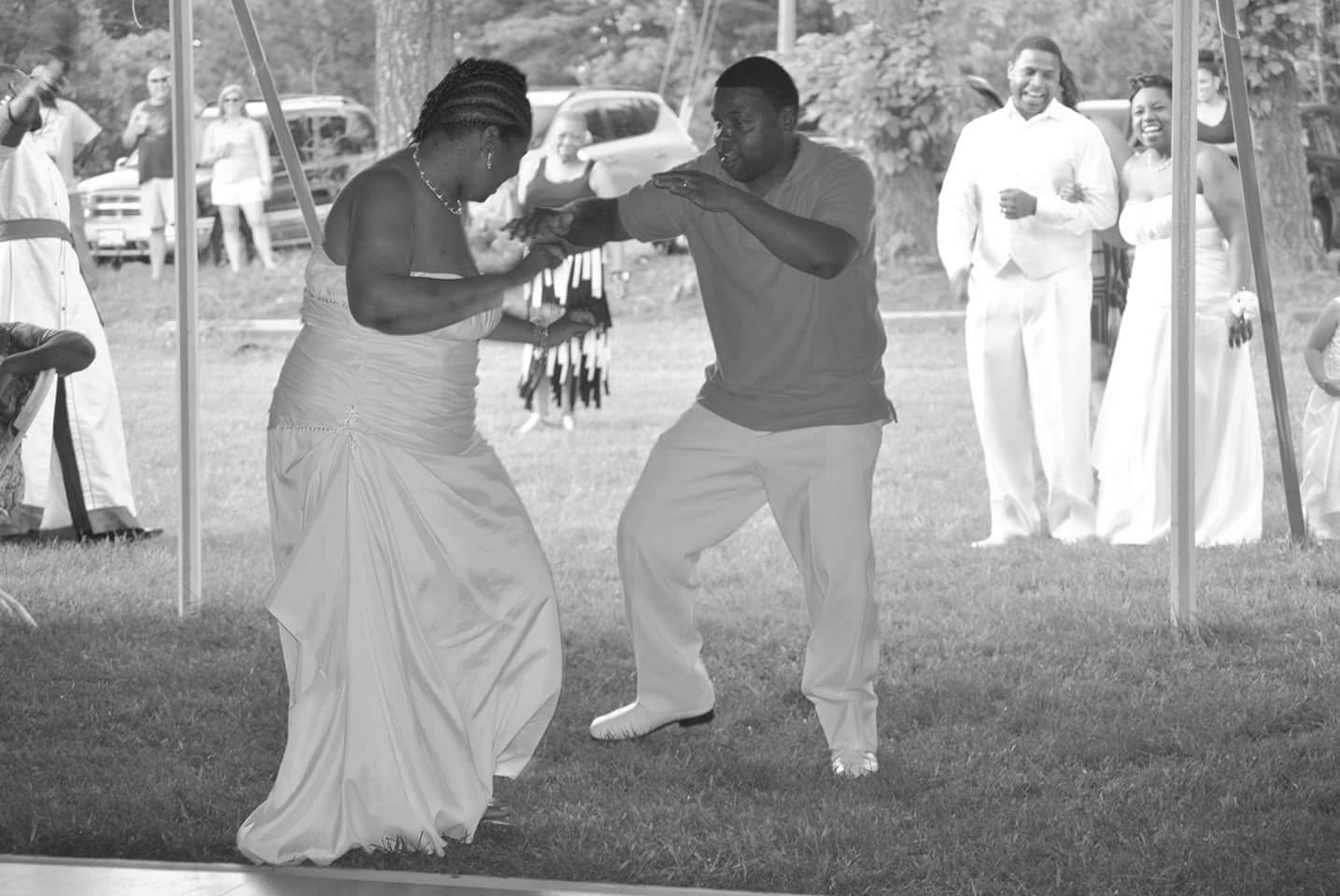 Wedding guests dancing together during an outdoor celebration