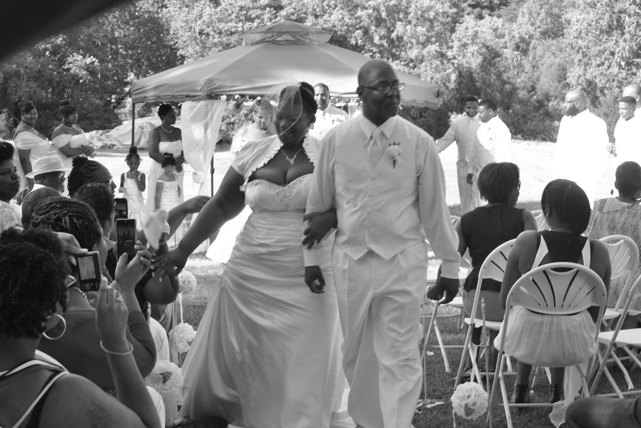 Newlyweds walking together after their outdoor ceremony