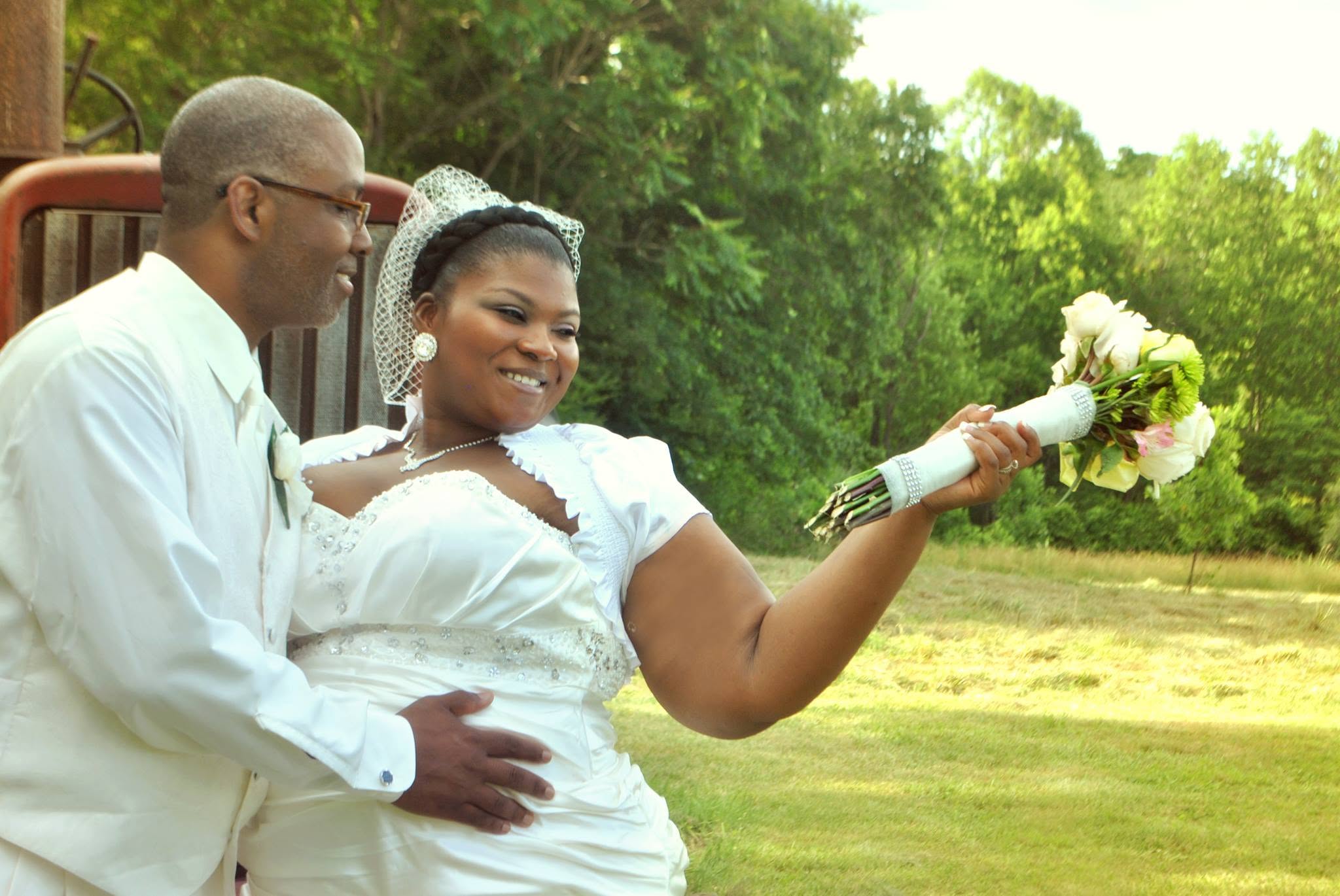 A joyful bride and groom posing outdoors after their wedding