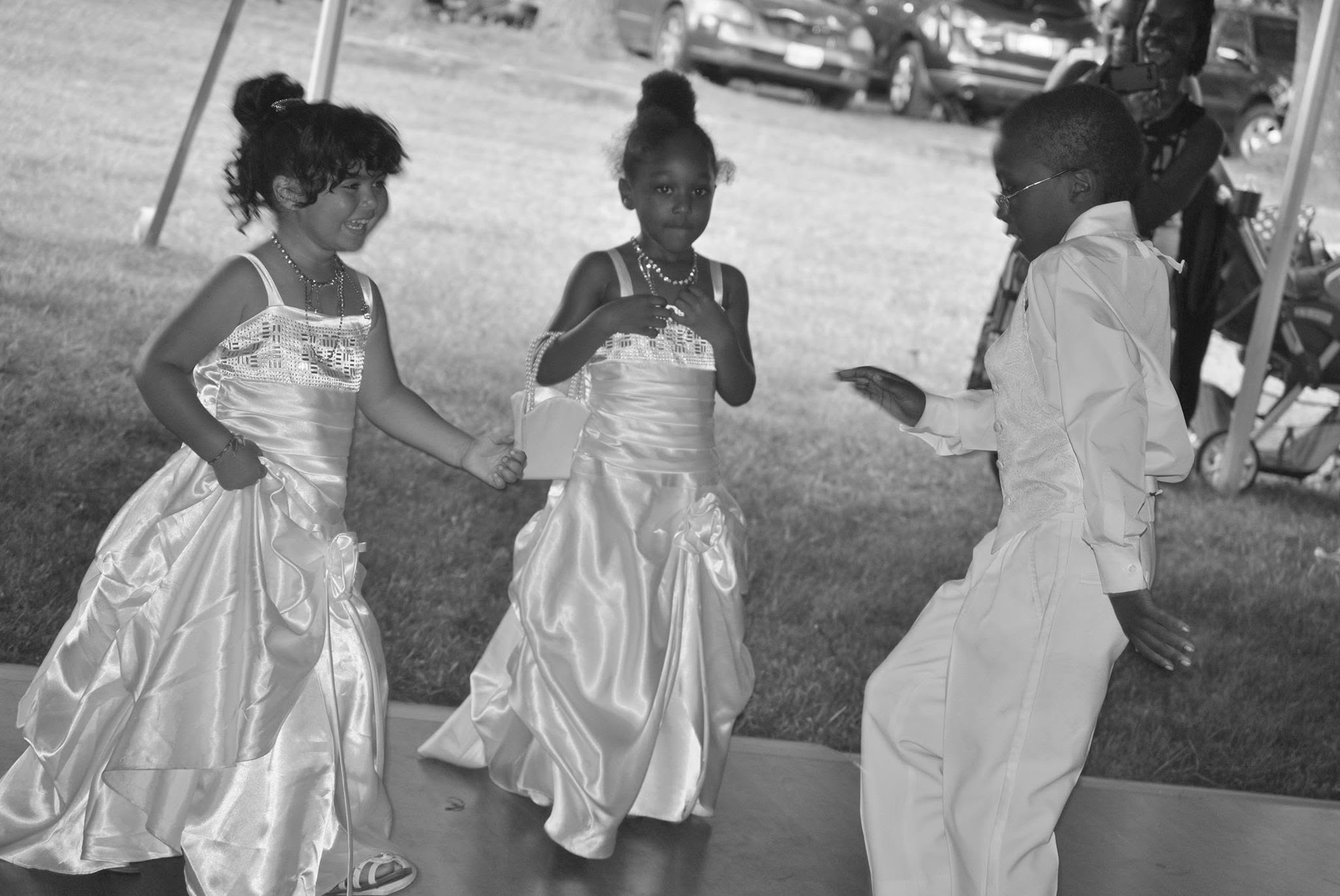 Young wedding attendants dancing together at the reception